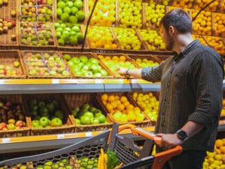 man in grocery store do shopping buying fruits copy space