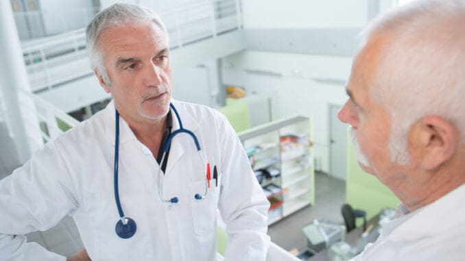 senior doctors talking on a bright stairway